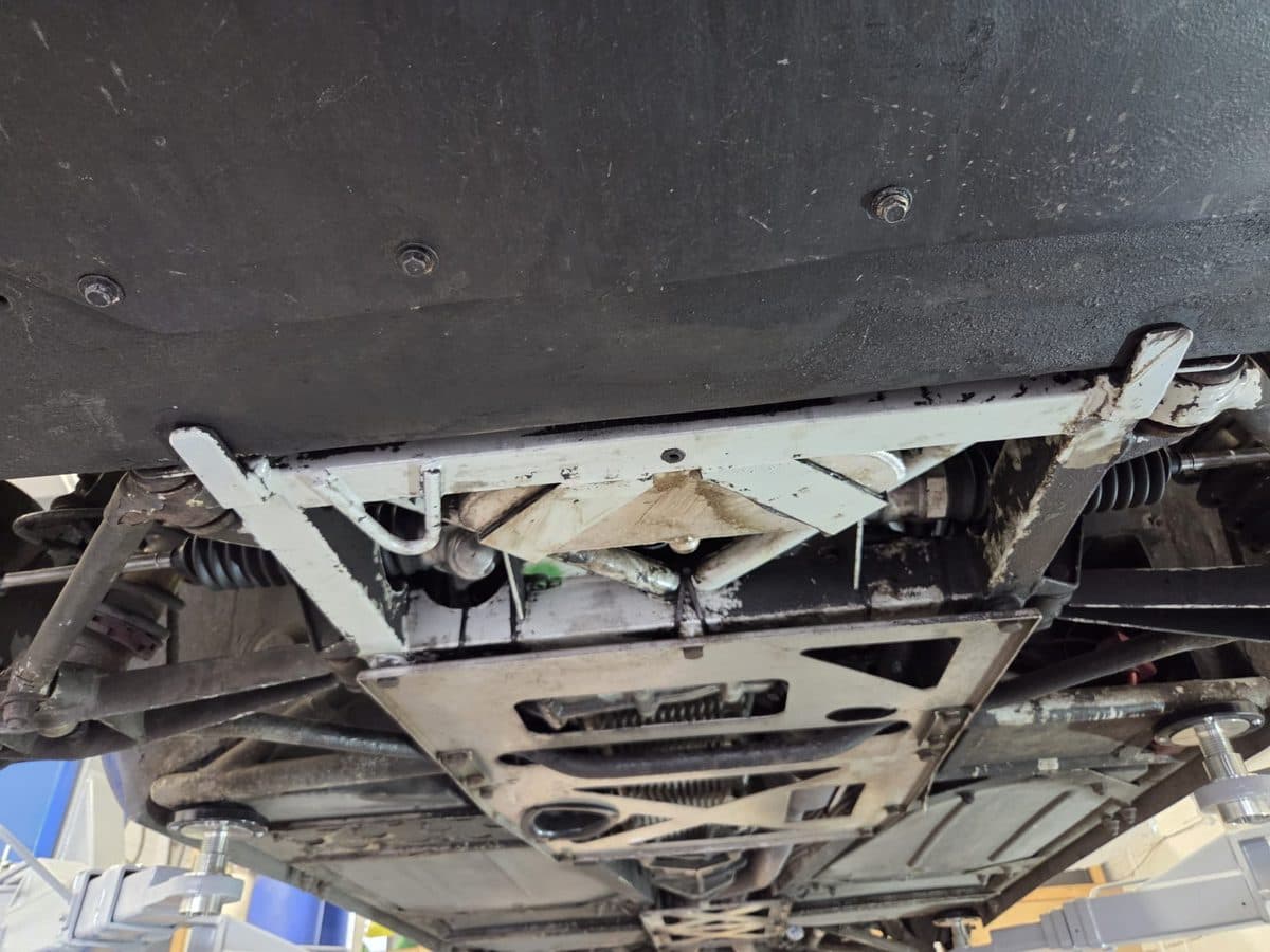 TVR Tuscan underside coated in road grime before dry ice cleaning