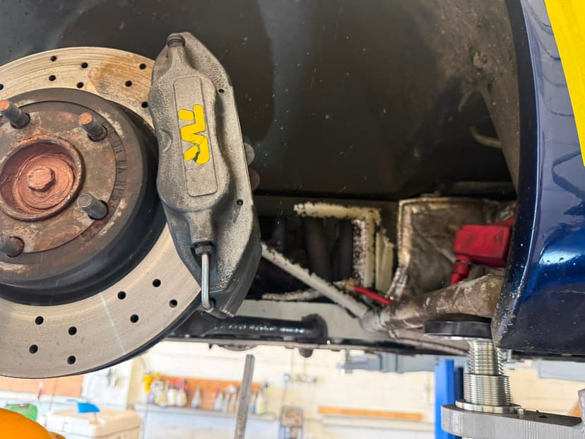 Brake caliper and cross-drilled disc after cleaning
