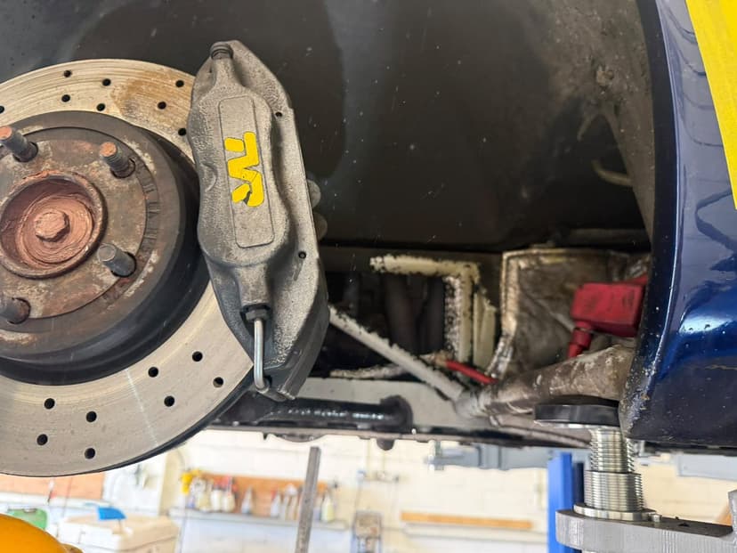 Brake caliper and cross-drilled disc after cleaning