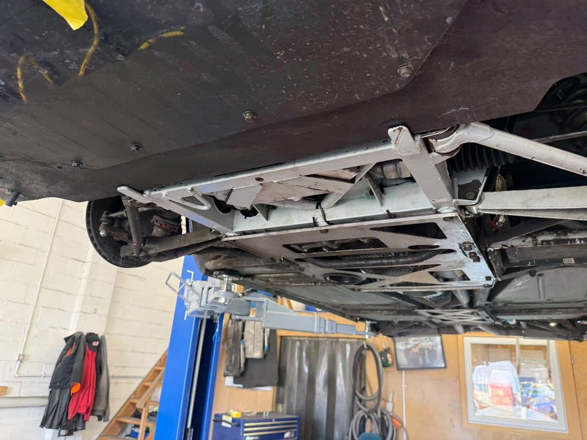 The same TVR Tuscan underside after dry ice cleaning, bare metal visible