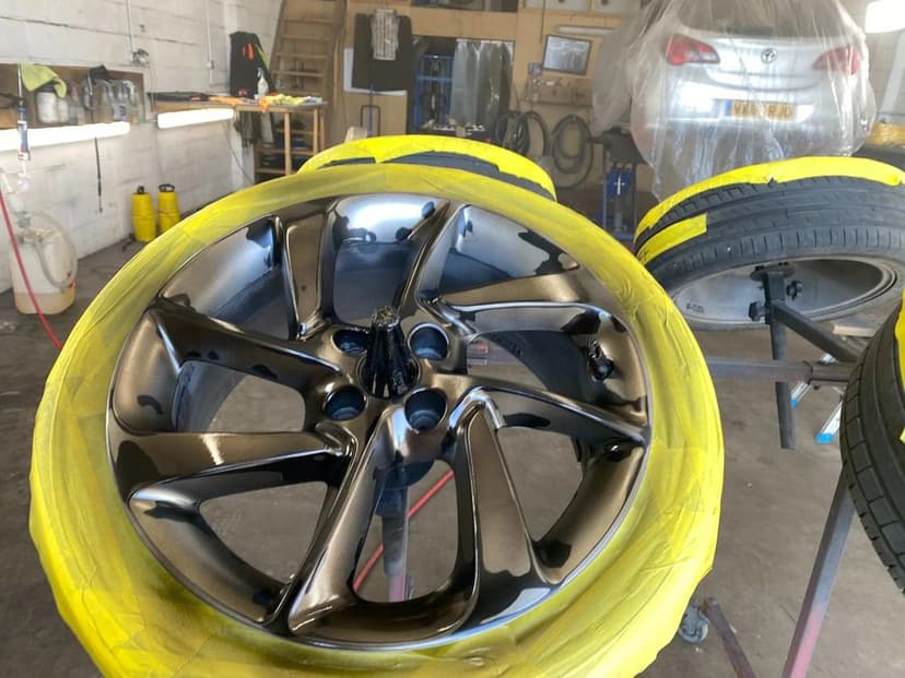 Alloy wheels masked and set up on stands inside the Mansfield Woodhouse unit