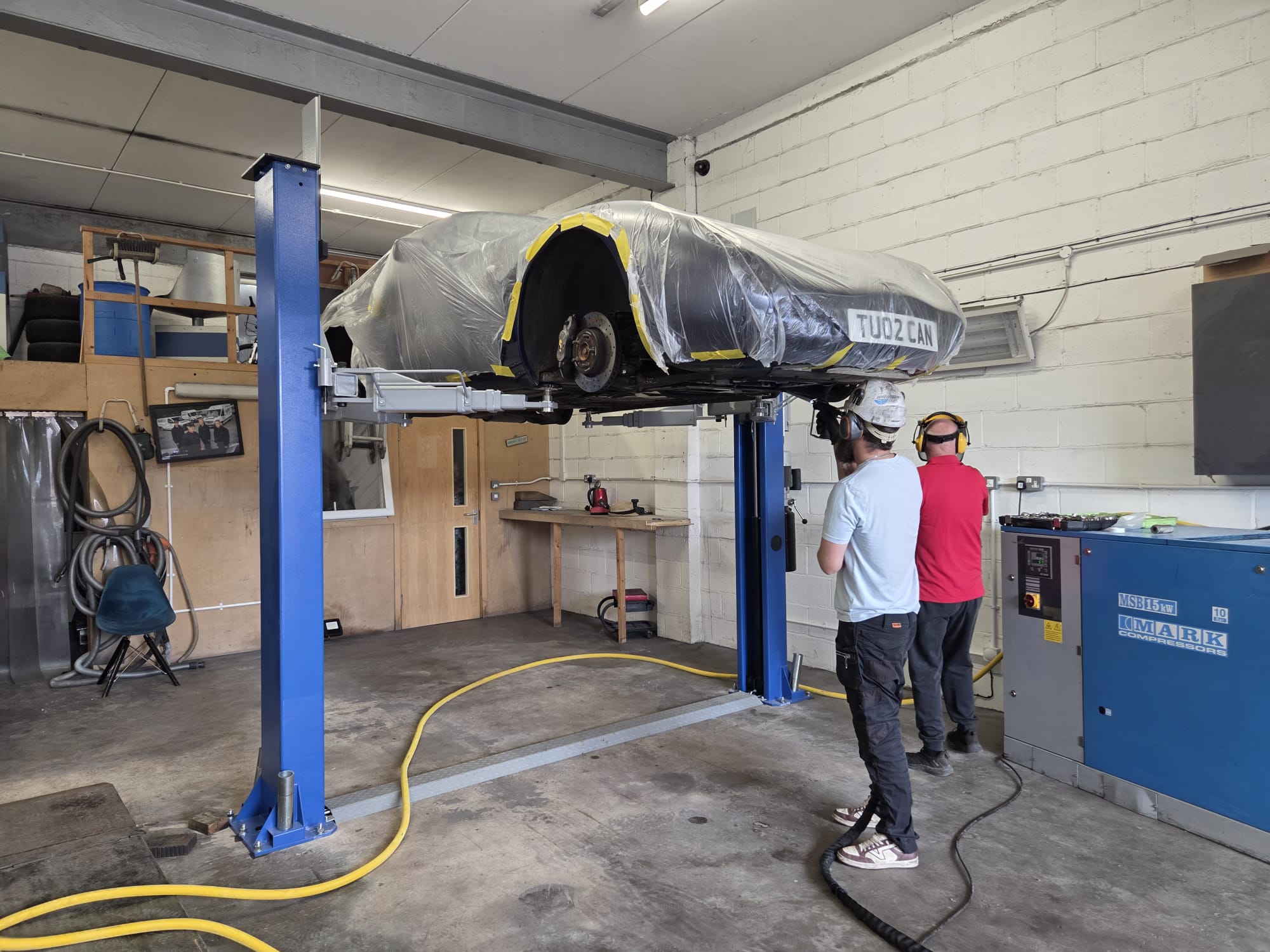 The Valet Man workshop with a car raised on the lift